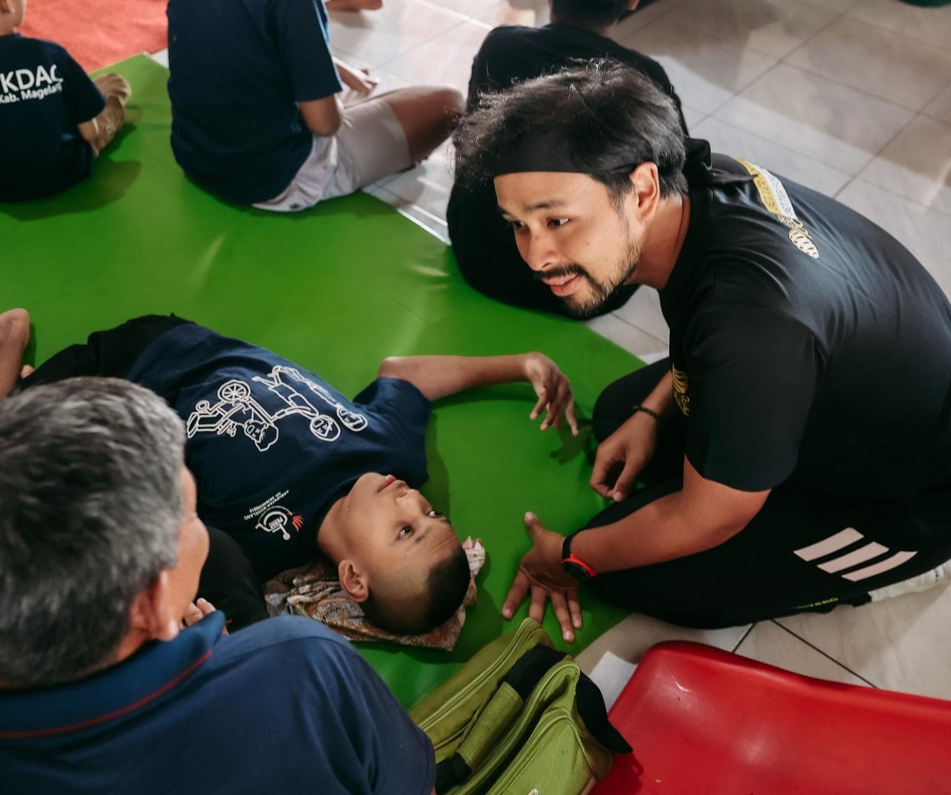 Pelari BOROBUDUR100 menemani anak bermain di atas matras